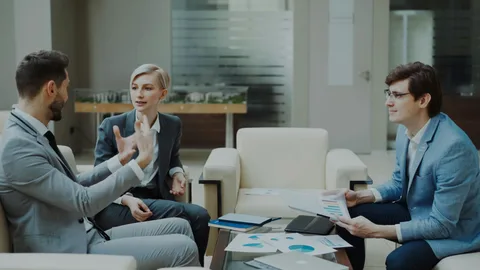 Executives in a strategic meeting in a corporate lounge